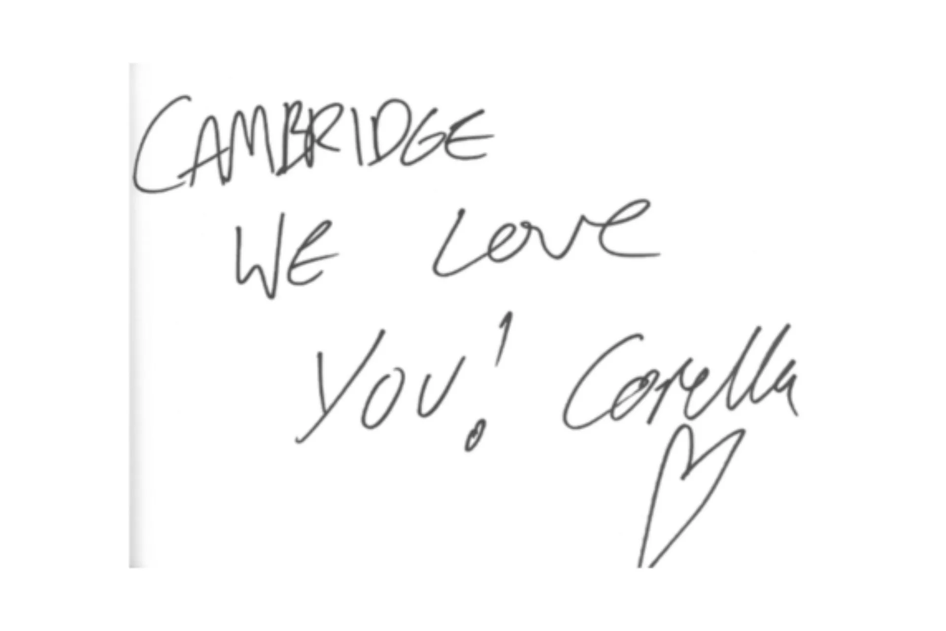 Image shows a white paper note that reads 'Cambridge we love you! Corella' in black ink.