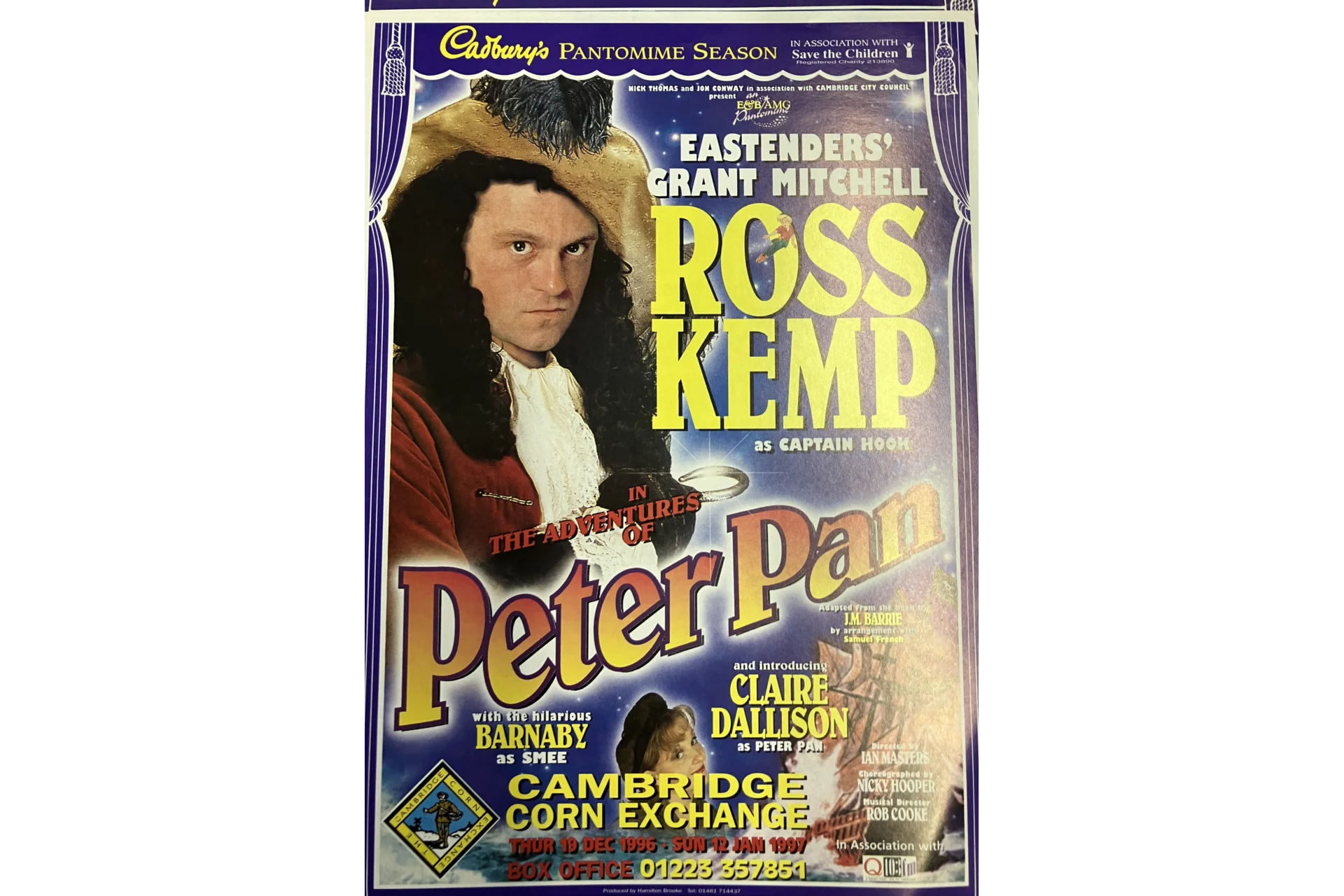 Image shows an 1990s advertisement poster for a pantomime production of The Adventures of Peter Pan. The image on the poster is of actor Ross Kemp dressed as Captain Hook on a purple background and the text of the poster outlines that the production will run at The Cambridge Corn Exchange from 19th December 1996 to 12th January 1997.