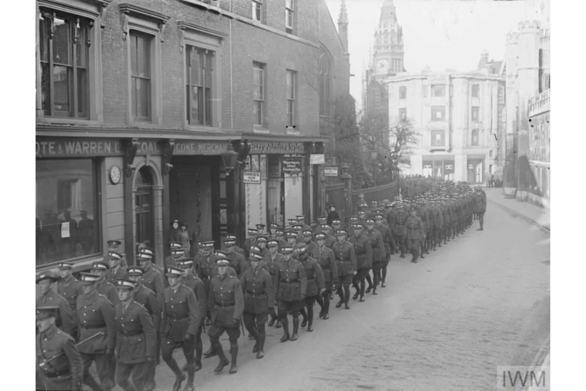 Black and white image of World War 1 Officer Cadets of No 2 Battalion parading outside St. Andrews Church opposite Christ's College on St. Andrew's Street, Cambridge.